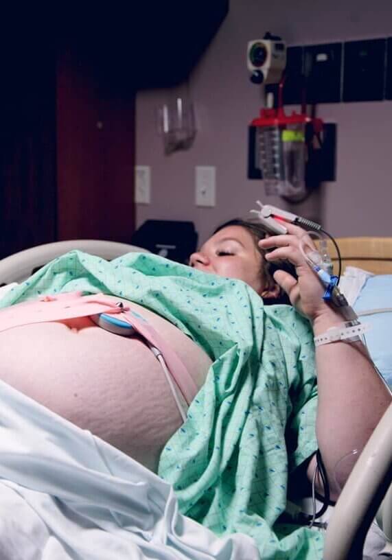A pregnant mother in a hospital bed